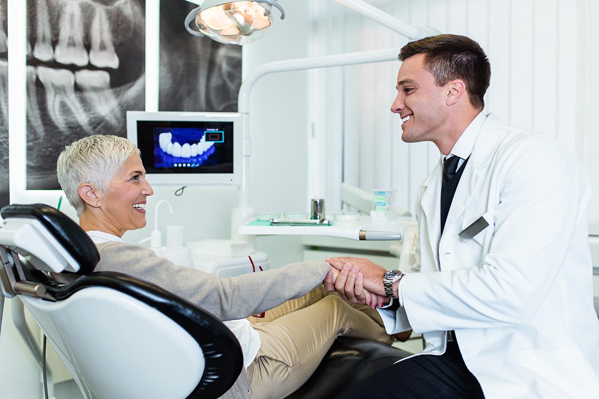 Beautiful senior woman having dental treatment at dentist's offi