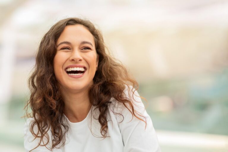 Smiling woman showing healthy teeth and a confident smile.