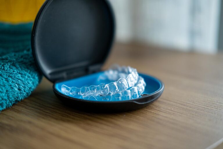 Clear aligners in a protective case used for orthodontic treatment.